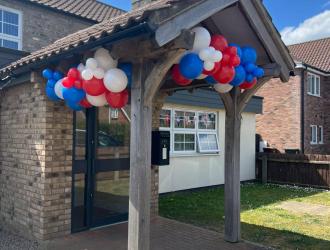 Front entrance with red white and blue balloons