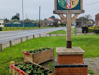 Village sign with winter plants and decoration